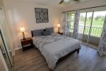 Primary bedroom with private lanai facing the mountains and golf course.